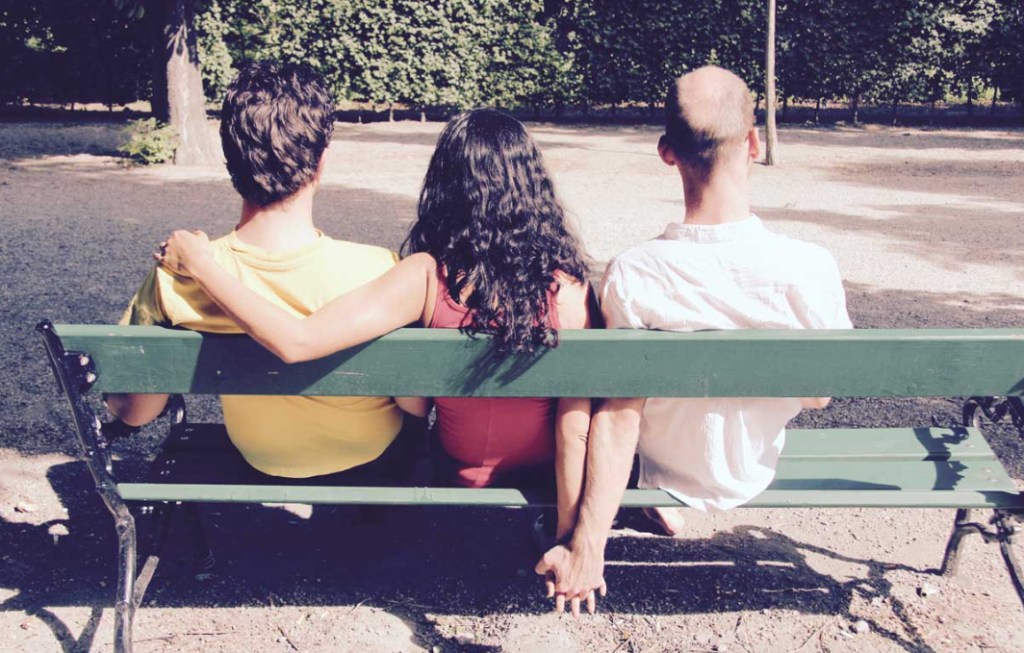 Three people sitting on a bench